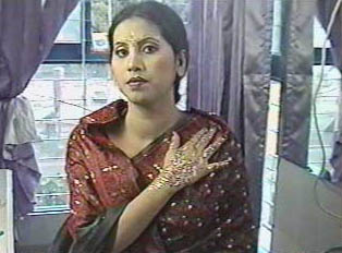 Bride displaying the henna work on her hands and the make-up artwork on her forehead