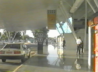 Airport drop-off area with departure and crosswalk signs