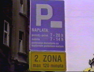Parking sign showing during what times there is a fee for parking 