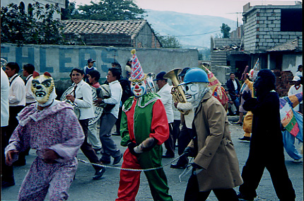 Parade including people with animal and clown costumes, and part of the town band