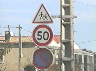 School crosswalk ahead and speed limit signs