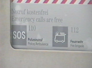 Emergency numbers displayed on a public phone