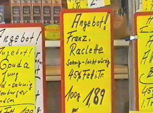 A yellow sign advertising cheese specials