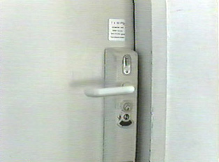 A coin deposit slot on a restroom door