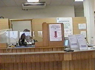 A bank teller behind a glass window