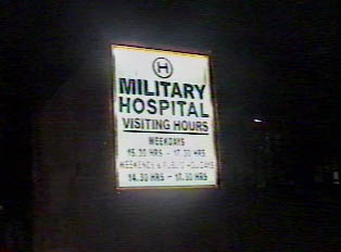Sign for a military hospital and its opening hours