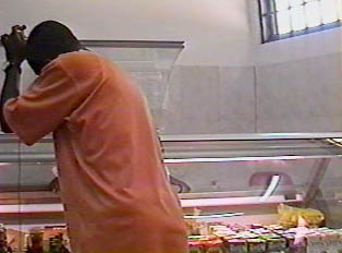 A customer helps himself in taking meat from the refrigerator