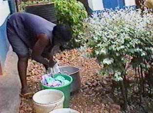 Woman doing her laundry in her backyard