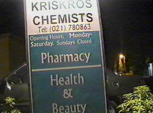 Sign for Kriskros Chemists and its opening hours