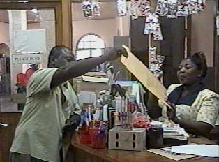 A man buying an envelope at a stationary store