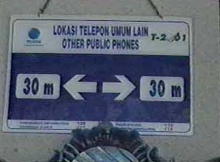 Sign indicating where to find public phones