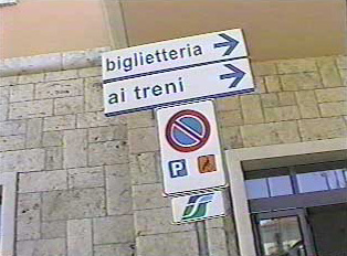 Directional sign to ticket agent and trains