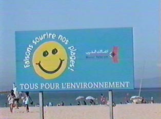 Sign in French and Arabic urging care for the beach environment