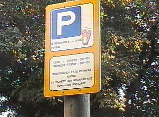 Sign listing parking fees and hours for street parking