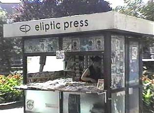 Newspaper stand where you can also buy phone cards