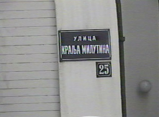 Street sign on side of building