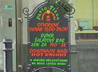 Pizza place sign indicating the hours and special menu items
