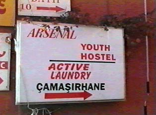 Street sign indicating hostel and laundry