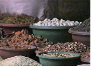 More  products sold by the vendor: almonds, pistachios, dried tamarind, and a white candy used at celebrations