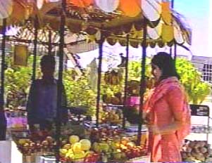 Woman purchasing fruits from vendor