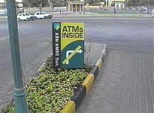 Sign at mall entrance indicating that there are ATM machines inside