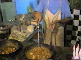 Chicken in a wok called 'chicken karahi' or 'balti gosht,' a dish from northern Pakistan showing Chinese influences