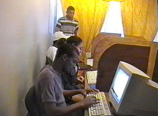 People on computers in an internet cafe