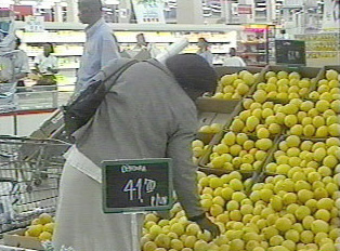 A person looking at produce in a supermarket