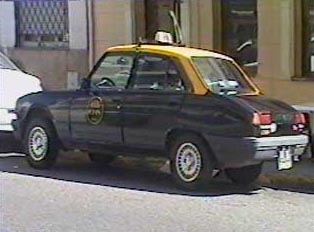 A black and yellow taxi