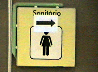 A yellow sign indicating a women's restroom