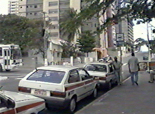 Several taxis parked by the curb