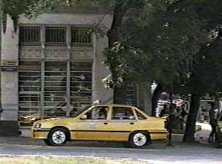 A yellow taxi parked alongside the street