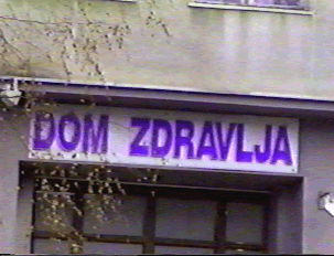A sign with purple letters indicating a health center