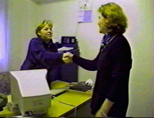 Two people greeting each other with a handshake