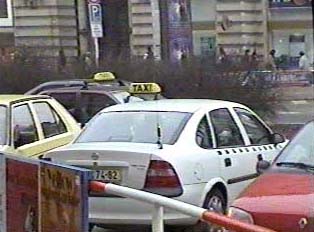 A parked white taxi