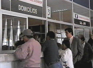 Several people in line at a post office