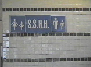 A light blue sign for a restroom