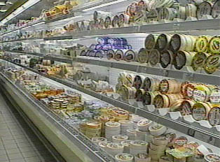 A display of cheese inside a supermarket