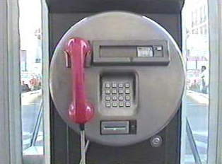 A public pay phone in a phone booth