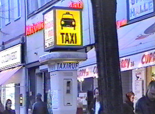 A rectangular yellow taxi sign