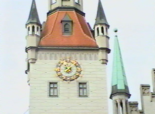 A golden clock on the outside of a tower