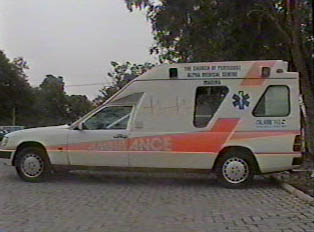 A white and orange ambulance parked inside a parking lot