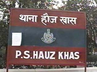 A large red and black sign for a police station
