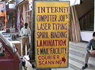 A sign advertising printing and internet services for an internet cafe