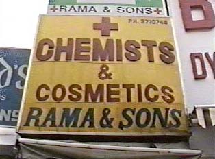 A large yellow and red sign advertising a pharmacy