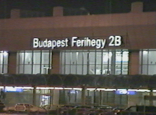 A view of the Budapest airport, with a lit up sign displaying the name