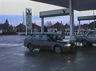 A sedan parked at a gas station