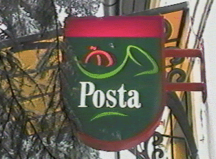 A small green sign for a post office