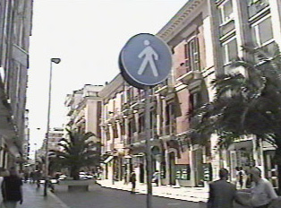 A circular pedestrain walk sign
