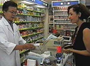 A person making a purchase at a pharmacy counter